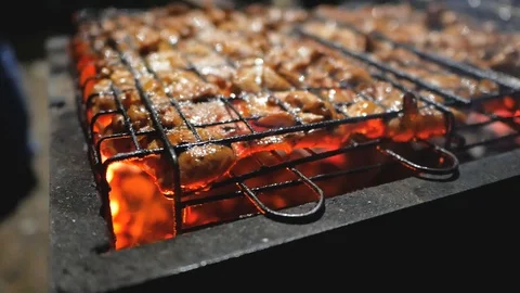 Pork, beef meat is fried on grills Stock Footage 129572836