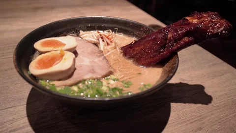 Pork broth based ramen topped with grilled marinated pork rib 動画素材 316538386