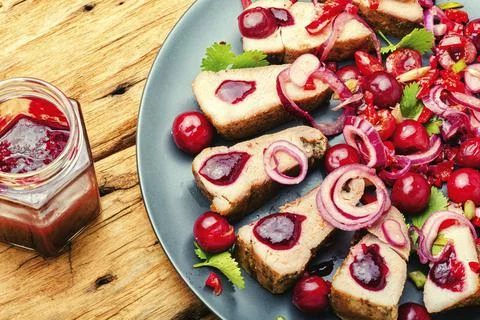 Pork with cherry sauce. Stock Photos