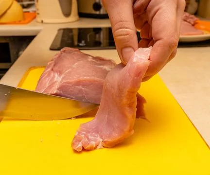 Pork chop cutting process on a yellow notch Stock Photos