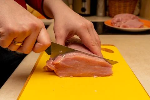 Pork chop cutting process on a yellow notch Stock Photos