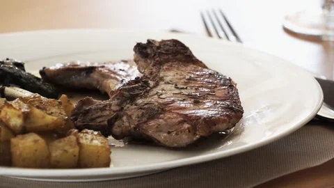 Pork chop on plate Stock Footage 89693642