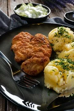 Pork chop served with mashed potatoes and cucumber salad. Stock Photos