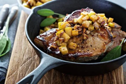 Pork chops with apples and walnuts Stock Photos