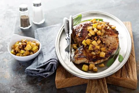 Pork chops with apples and walnuts Stock Photos