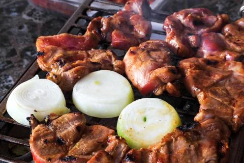 Pork chops on grill Stock Photos
