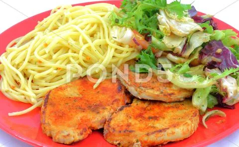 Pork chops with pasta and salad Stock Photos