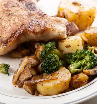 Pork chops with vegetables Stock Photos