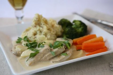 Pork in cider sauce with wholegrain mustard mash and vegetables Stock Photos
