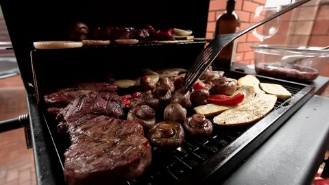 Pork cuts - steaks along with vegetables are grilled. Video stock 144353065