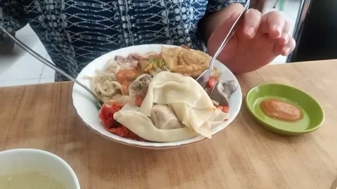 Pork Dumpling Noodles with characteristic yellow chilies Stock Footage 280072463