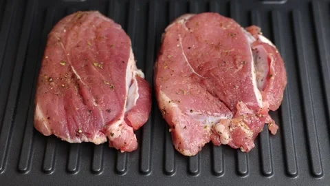 Pork is fried in a grill pan. Stock Footage 220742159