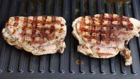 Pork is fried in a grill pan. Stock Footage 220742288