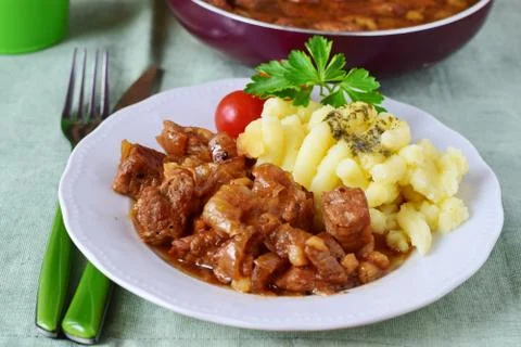 Pork fried with onions on a plate with mashed potato. Home cooking. Stock Photos