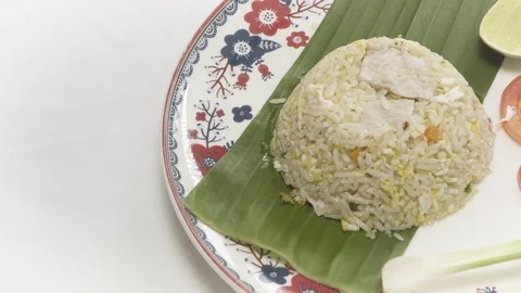 Pork fried rice served with vegetables on banana leaves Stock Footage 128677564