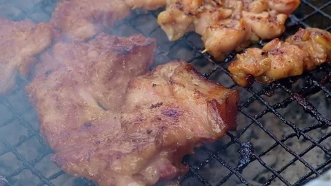Pork grill over the small flame. shallow DOF. 4K, UHD. Stock Footage 79872224
