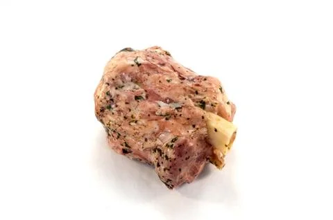 Pork ham with its bone and green parsley Stock Photos