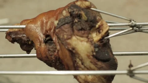 Pork ham roasted on an open fire Stock Footage 64260640