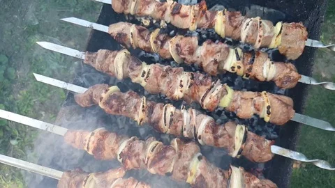 Pork kebab cooked on the grill, strung on skewers, top view, slow motion Video stock 109503585