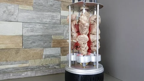 Pork kebab is fried at home on a vertical electric grill. roast meat at home Stock Footage 168587292