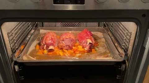 Pork knuckle baked on a baking sheet in the oven Stock Footage 290766524