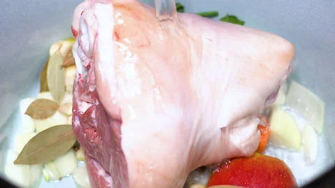 Pork knuckle instead of vegetables is cooked in a saucepan Stock Footage 249598573