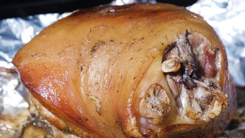 Pork knuckle is removed from the oven Stock Footage 85163812