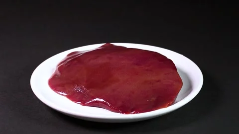 Pork liver on a plate, rotating Stock Footage 304254028