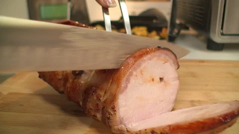 Pork loin. Chef cuts meat in kitchen. cu Stock Footage 101712926