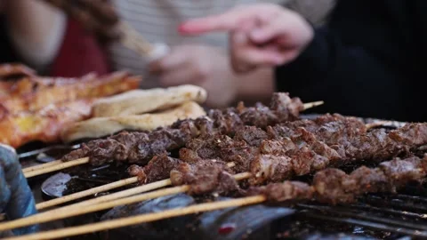 Pork meat skewer on fire, Mutton barbecue close-up. Fried meat for kebab Stock Footage 265913836