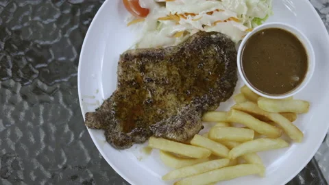 Pork or beef steak served with vegetable salad On a clean plate No germs or Coro Stock Footage 142214651