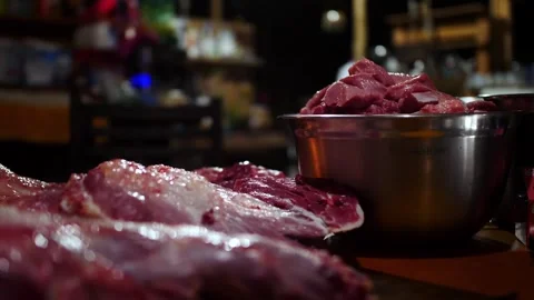 Pork ribcage raw meat slab with a metal bowl containing extra pork chunks Stock Footage 344239134
