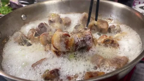 Pork ribs cooking in pan, authentic Vietnamese street food Video stock 327844705