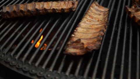 Pork ribs grill roasted on a rotating grill. Fried pork barbecue. Street food Stock Footage 124324476
