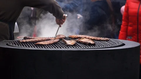 Pork ribs grill roasted on a rotating grill. Fried pork barbecue. Street food Stock Footage 124324491