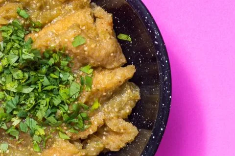 Pork rinds in green salsa with refried beans Stock Photos