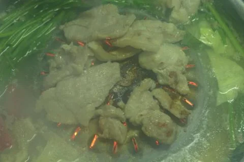 The pork is roasting fire, causing smoke and blurry. Stock Photos