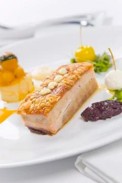 Pork served with condiments Stock Photos