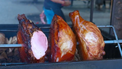 Pork shanks rotating on a spit roaster, street food delicacy 스톡 동영상 333395469