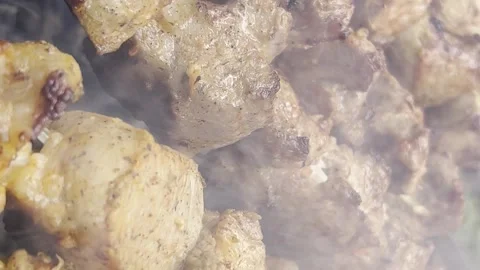 Pork shish kebab, which is roasted on a fire in the open air. Cooking meat on Stock Footage 250352436