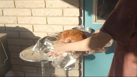 Pork shoulder placed on table next to bbq smoker Stock Footage 244689340