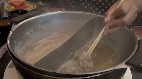 The pork slice dipped in boiling broth in a restaurant, Shabu Japanese food Stock Footage 106522646