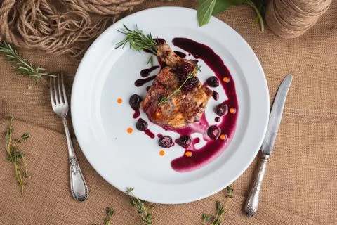 Pork steak on the bone with cherry-ginger sauce Stock Photos