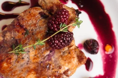 Pork steak on the bone with cherry-ginger sauce Stock-Fotos