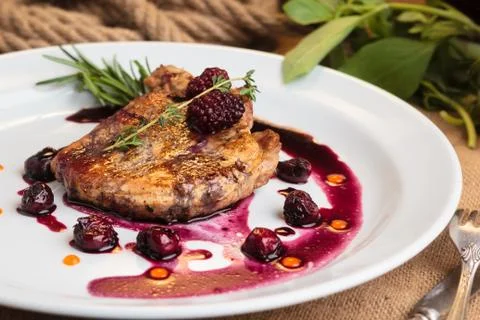 Pork steak on the bone with cherry-ginger sauce 스톡 사진