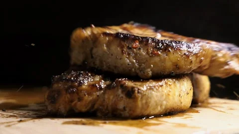 A pork steak falling onto another steak Video stock 166748189