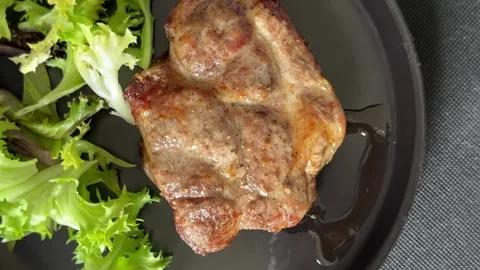 Pork steak roasted meat grilled barbecue main course lunch or dinner tasty food Stock Footage 335655121