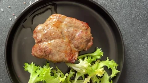 Pork steak roasted meat grilled barbecue main course lunch or dinner tasty food Stock Footage 335655124