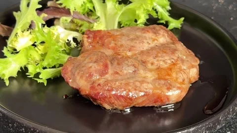 Pork steak roasted meat grilled barbecue main course lunch or dinner tasty food Stock Footage 335655125