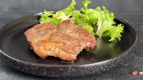 Pork steak roasted meat grilled barbecue main course lunch or dinner tasty food Stock Footage 335655128